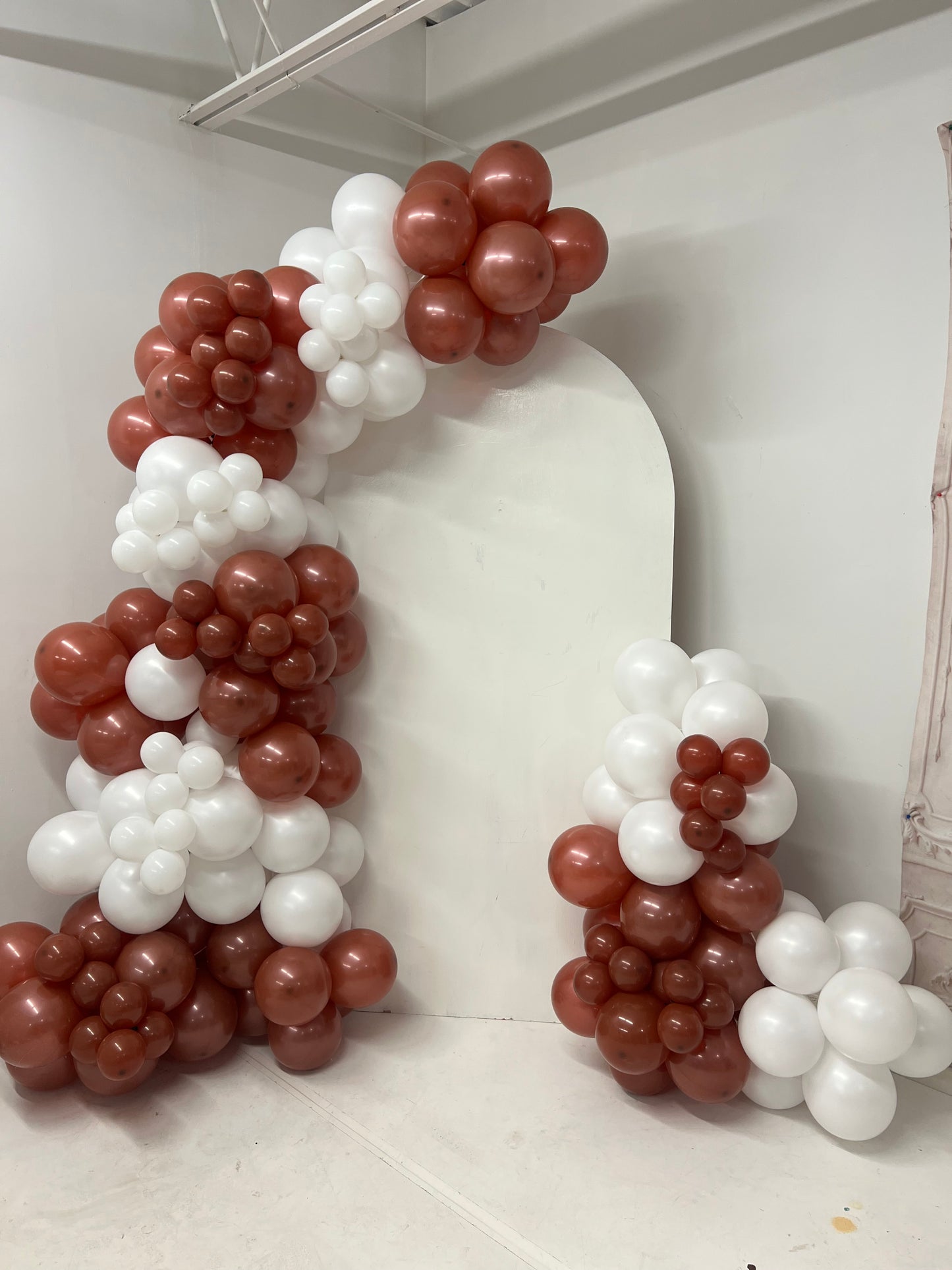 Maroon and white balloon arch